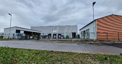 A building with a fence and grass AI-generated content may be incorrect.