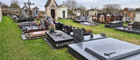 A cemetery with gravestones and a church AI-generated content may be incorrect.